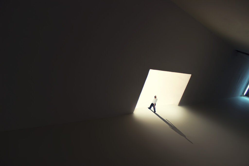 Minimalist fine art photography from the 'Comatose' collection, exploring consciousness through solitary silhouettes, stark shadows, and blinding geometric light.