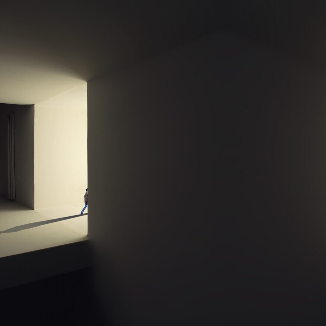 Minimalist fine art photography from the 'Comatose' collection, exploring consciousness through solitary silhouettes, stark shadows, and blinding geometric light.