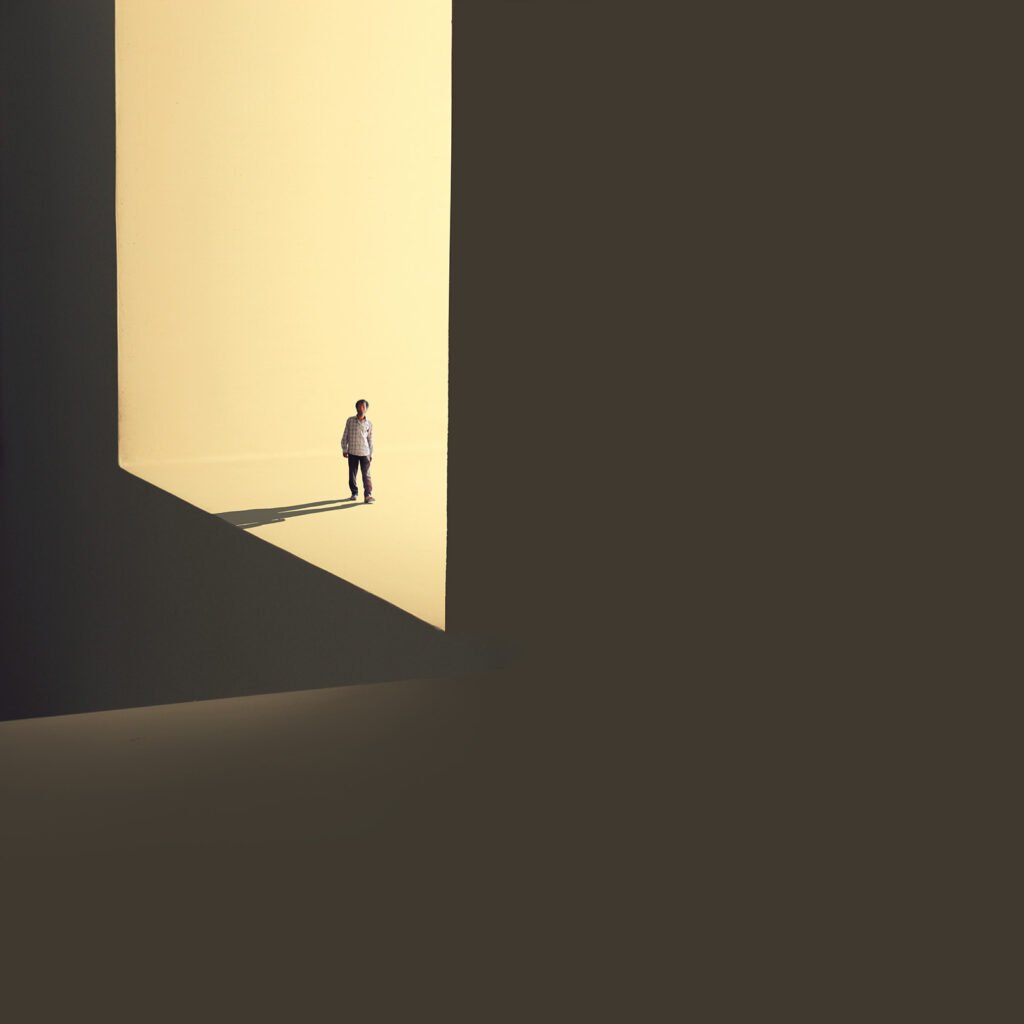 Minimalist fine art photography from the 'Comatose' collection, exploring consciousness through solitary silhouettes, stark shadows, and blinding geometric light.